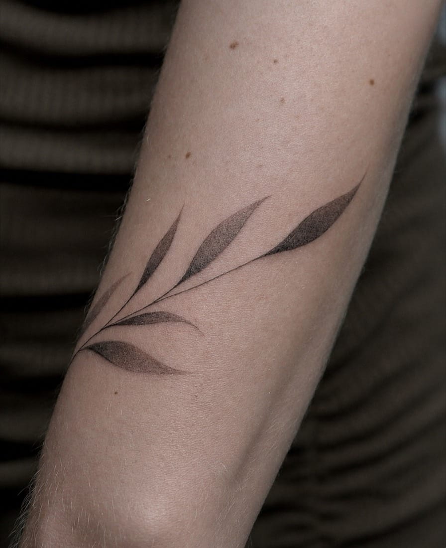 Fine line botanical leaf branch tattoo by a Manchester Fine Line Tattoo Academy student