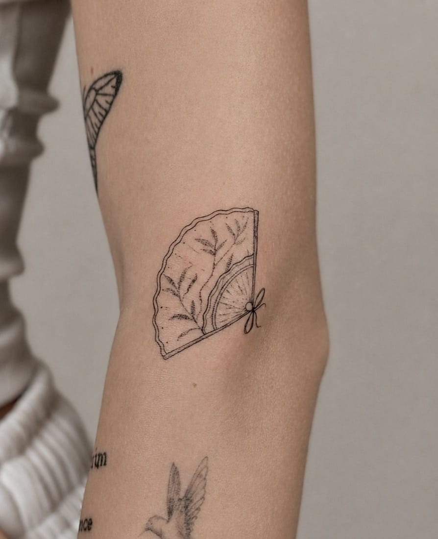 Fine line folding fan with foliage tattoo by a Manchester Fine Line Tattoo Academy student